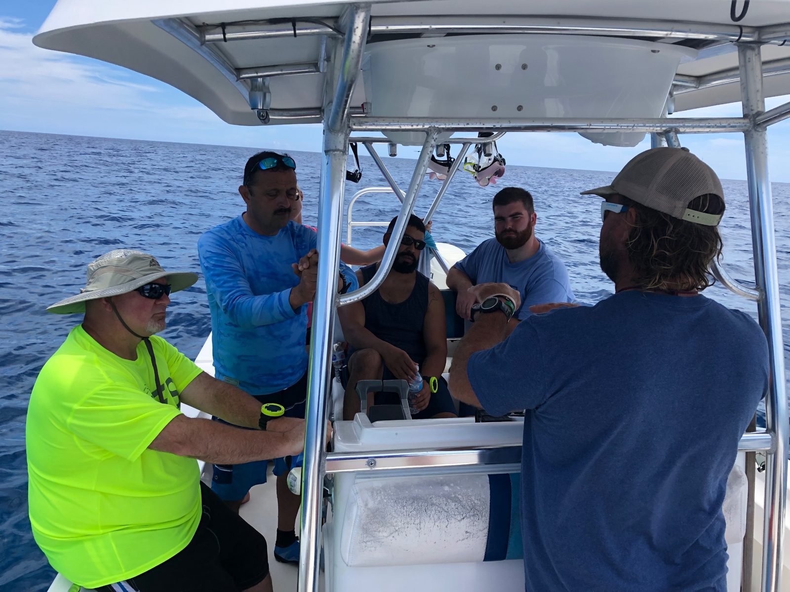 Leadership team getting a dive briefing on a boat